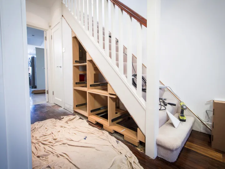 Before and after understairs storage cupboard installation in London hallway